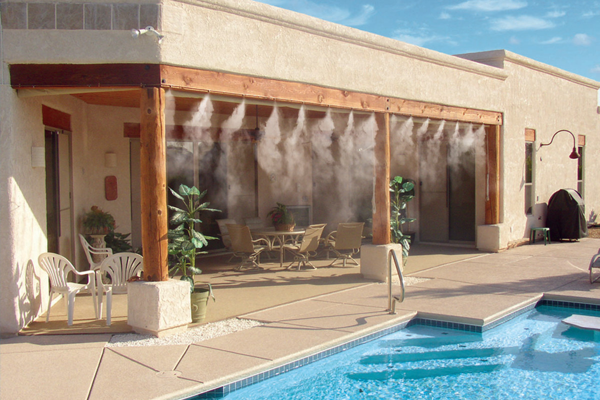 misting system by pool in backyard